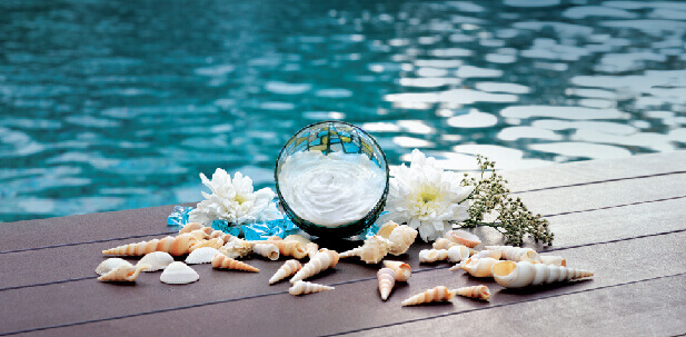 decoration made of shells and flowers next to a pool