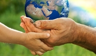 a small and a large hand holding the Earth together