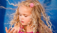 little blonde girl looking at hand